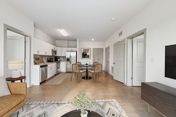 A modern kitchen with a dining table and chairs